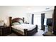 Well-lit bedroom featuring elegant furnishings, a plush bed, and decorative curtains for a relaxing ambiance at 901 Golden Shiner Ave, Ruskin, FL 33570