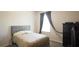 This bedroom features neutral walls, carpet flooring, and a cushioned headboard for comfortable sleeping at 901 Golden Shiner Ave, Ruskin, FL 33570