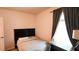 This bedroom features neutral walls, carpet flooring, and a dark wood headboard at 901 Golden Shiner Ave, Ruskin, FL 33570
