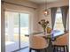 Cozy dining area features a modern table, stylish chairs, and sliding glass doors to the outdoors at 901 Golden Shiner Ave, Ruskin, FL 33570