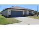 Well-maintained home exterior featuring a two-car garage, manicured lawn, and inviting curb appeal at 901 Golden Shiner Ave, Ruskin, FL 33570