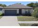 Charming single-story home featuring a well-manicured lawn, neutral paint, and a convenient two-car garage at 901 Golden Shiner Ave, Ruskin, FL 33570