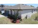 Landscaped front yard with a well-maintained lawn, mature plants, and an irrigation system for easy upkeep at 901 Golden Shiner Ave, Ruskin, FL 33570