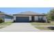 Charming single-story home featuring a two-car garage and well-maintained front lawn at 901 Golden Shiner Ave, Ruskin, FL 33570