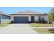 Charming single-story home featuring a two-car garage and well-maintained front lawn at 901 Golden Shiner Ave, Ruskin, FL 33570