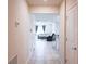 This hallway features neutral walls, tiled floors, and a view into the living room at 901 Golden Shiner Ave, Ruskin, FL 33570