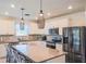 Modern kitchen with a granite island, stainless appliances, and pendant lighting at 901 Golden Shiner Ave, Ruskin, FL 33570