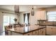 Bright kitchen area with an island, pendant lighting, and stainless steel appliances at 901 Golden Shiner Ave, Ruskin, FL 33570