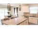 Modern kitchen featuring a large island, pendant lights, and stainless steel appliances with dining area at 901 Golden Shiner Ave, Ruskin, FL 33570