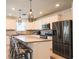 Modern kitchen features white cabinets, granite counters, stainless appliances and stylish pendant lighting at 901 Golden Shiner Ave, Ruskin, FL 33570