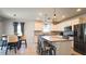 Island kitchen and dining space with stainless appliances and modern fixtures at 901 Golden Shiner Ave, Ruskin, FL 33570