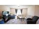 Cozy living room boasts a plush sectional, recliner, and large-screen television for entertainment at 901 Golden Shiner Ave, Ruskin, FL 33570