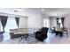 Open living room featuring a comfortable sectional sofa, recliner, and adjacent dining area with stylish decor at 901 Golden Shiner Ave, Ruskin, FL 33570