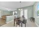 Bright dining area with natural light, featuring tile flooring and seamless connection to the living room at 9102 Kentucky Day Ct, Gibsonton, FL 33534
