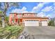 Charming two-story home with a front-facing two-car garage and a beautifully maintained lawn at 9102 Kentucky Day Ct, Gibsonton, FL 33534