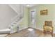 Bright foyer featuring hardwood floors, a staircase, and a decorative glass door at 9102 Kentucky Day Ct, Gibsonton, FL 33534