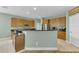 Spacious kitchen with wood cabinets, granite countertops, stainless steel appliances, and tile floors at 9102 Kentucky Day Ct, Gibsonton, FL 33534