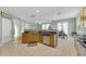 Open concept kitchen featuring granite countertops, stainless steel dishwasher, and tiled floors, adjacent to dining area at 9102 Kentucky Day Ct, Gibsonton, FL 33534