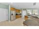 Bright kitchen with stainless steel appliances and tile flooring, connecting seamlessly to other living spaces at 9102 Kentucky Day Ct, Gibsonton, FL 33534