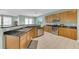 Modern kitchen featuring stainless steel appliances, granite countertops, and wood cabinets at 9102 Kentucky Day Ct, Gibsonton, FL 33534