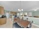 Open concept kitchen with stainless steel refrigerator seamlessly connected to the dining room and living areas at 9102 Kentucky Day Ct, Gibsonton, FL 33534