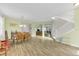 Open concept living space with hardwood floors, staircase, and dining area with antique furniture at 9102 Kentucky Day Ct, Gibsonton, FL 33534