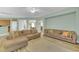 Open concept living room with hardwood floors and neutral tones, flowing into adjacent living spaces at 9102 Kentucky Day Ct, Gibsonton, FL 33534