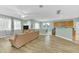 Spacious living room with wood flooring, ceiling fan, and seamless flow to kitchen and dining area at 9102 Kentucky Day Ct, Gibsonton, FL 33534