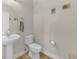 Cozy half-bathroom featuring a pedestal sink, toilet, and neutral wall paint at 9102 Kentucky Day Ct, Gibsonton, FL 33534