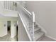 Carpeted staircase features white railings and natural light streaming in at 9102 Kentucky Day Ct, Gibsonton, FL 33534