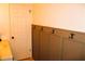 Neutral colored entryway with wall-mounted coat rack and white paneled door at 9626 Leeward Ave, Largo, FL 33773