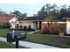 Charming single story home with manicured front yard and appealing stone accents at 9626 Leeward Ave, Largo, FL 33773