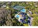 Aerial view displays the community's pools, clubhouse, tennis courts, and surrounding lush greenery at 10228 Estuary Dr, Tampa, FL 33647