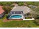 Aerial view of a private pool and backyard, showcasing a serene outdoor living space surrounded by lush greenery at 10228 Estuary Dr, Tampa, FL 33647