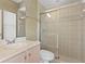 Well-lit bathroom features a step-in shower with glass doors, a vanity with storage, and updated hardware at 10228 Estuary Dr, Tampa, FL 33647