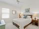 Bright bedroom with neutral decor, plush carpet, and a ceiling fan at 10228 Estuary Dr, Tampa, FL 33647