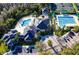 Aerial view shows community amenities including pools, clubhouse, and parking, surrounded by lush landscaping at 10228 Estuary Dr, Tampa, FL 33647