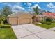Well-maintained home featuring a tile roof, mature landscaping, and a spacious three-car garage at 10228 Estuary Dr, Tampa, FL 33647