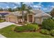 Charming single-story home with well-manicured landscaping, a tile roof, and an inviting front entrance at 10228 Estuary Dr, Tampa, FL 33647