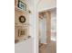 Hallway featuring decorative shelves leads to the bright main bathroom at 10228 Estuary Dr, Tampa, FL 33647