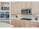 Kitchen featuring a stainless steel microwave, oven, and cooktop with a gas range at 10228 Estuary Dr, Tampa, FL 33647