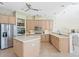 Bright kitchen features stainless steel appliances, breakfast bar, and light wood cabinetry at 10228 Estuary Dr, Tampa, FL 33647