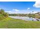 Wonderful lake view reflecting the surrounding homes and blue sky with scattered clouds at 10228 Estuary Dr, Tampa, FL 33647