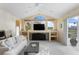 Inviting living room with entertainment center, large windows, and easy access to the patio at 10228 Estuary Dr, Tampa, FL 33647