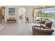 Bright and spacious living area with fireplace, tile floors, and screened patio at 10228 Estuary Dr, Tampa, FL 33647