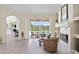 Bright living room with fireplace, tile floors, and sliding doors to the patio at 10228 Estuary Dr, Tampa, FL 33647