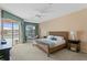 Relaxing main bedroom featuring patio access, sitting area, and an ensuite bathroom at 10228 Estuary Dr, Tampa, FL 33647