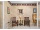Study room featuring two wooden chairs, a modern desk, and wall art, offering a traditional and functional workspace at 10228 Estuary Dr, Tampa, FL 33647
