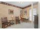 Study features two wooden chairs, a modern desk, and wall art, creating a traditional and functional workspace at 10228 Estuary Dr, Tampa, FL 33647