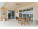Covered outdoor patio features dining table with a view of the screened-in pool, ideal for relaxation at 10228 Estuary Dr, Tampa, FL 33647